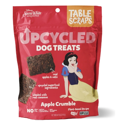 Red packaging for upcycled dog treats with an apple crumble flavor. Features dog treat images and a Snow White illustration, emphasizing real apples and oats.