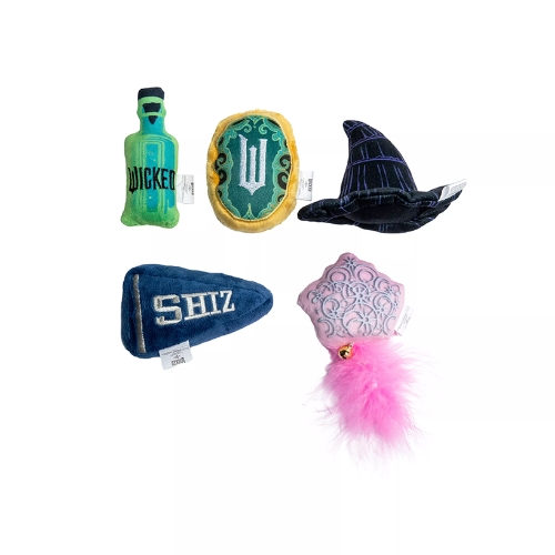 Plush toys inspired by Wicked. Includes a green potion bottle, witch hat, school pennant, spell book, and pink wand with feathers.