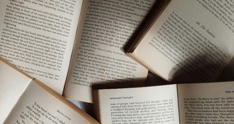 This image features open books stacked on top of each other.