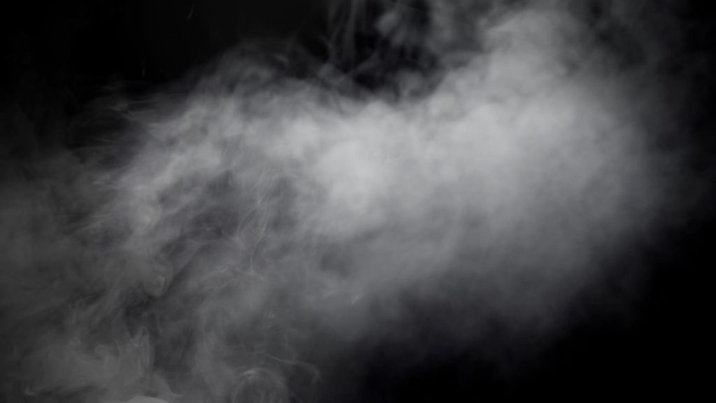 Gray fog floating across a black background.