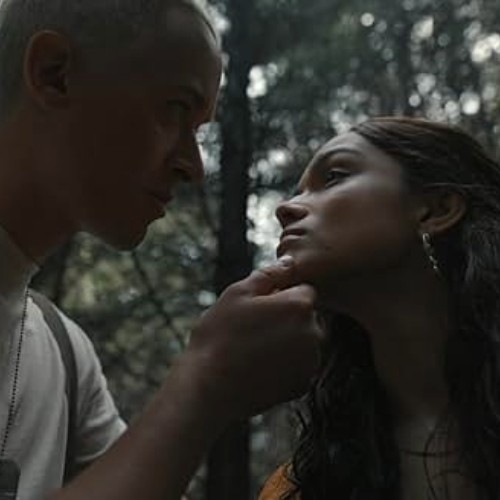 Movie still of Lucy Gray and Snow displaying an intimate gaze.