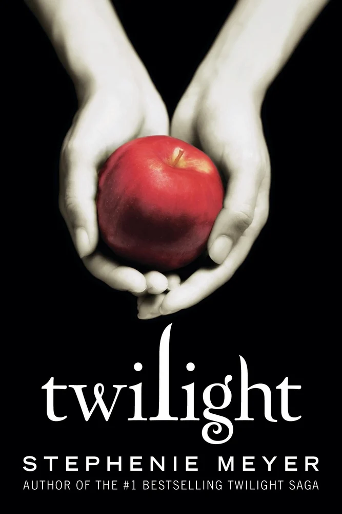 Twilight by Stephenie Meyer depicts a pair of hands holding a bright red apple.