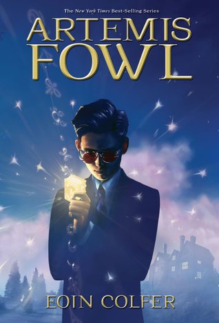 Young boy in a suit, holding a glowing cube, stands in a misty landscape. The sky is filled with stars, with the title "Artemis Fowl" in a gold font at the top.
