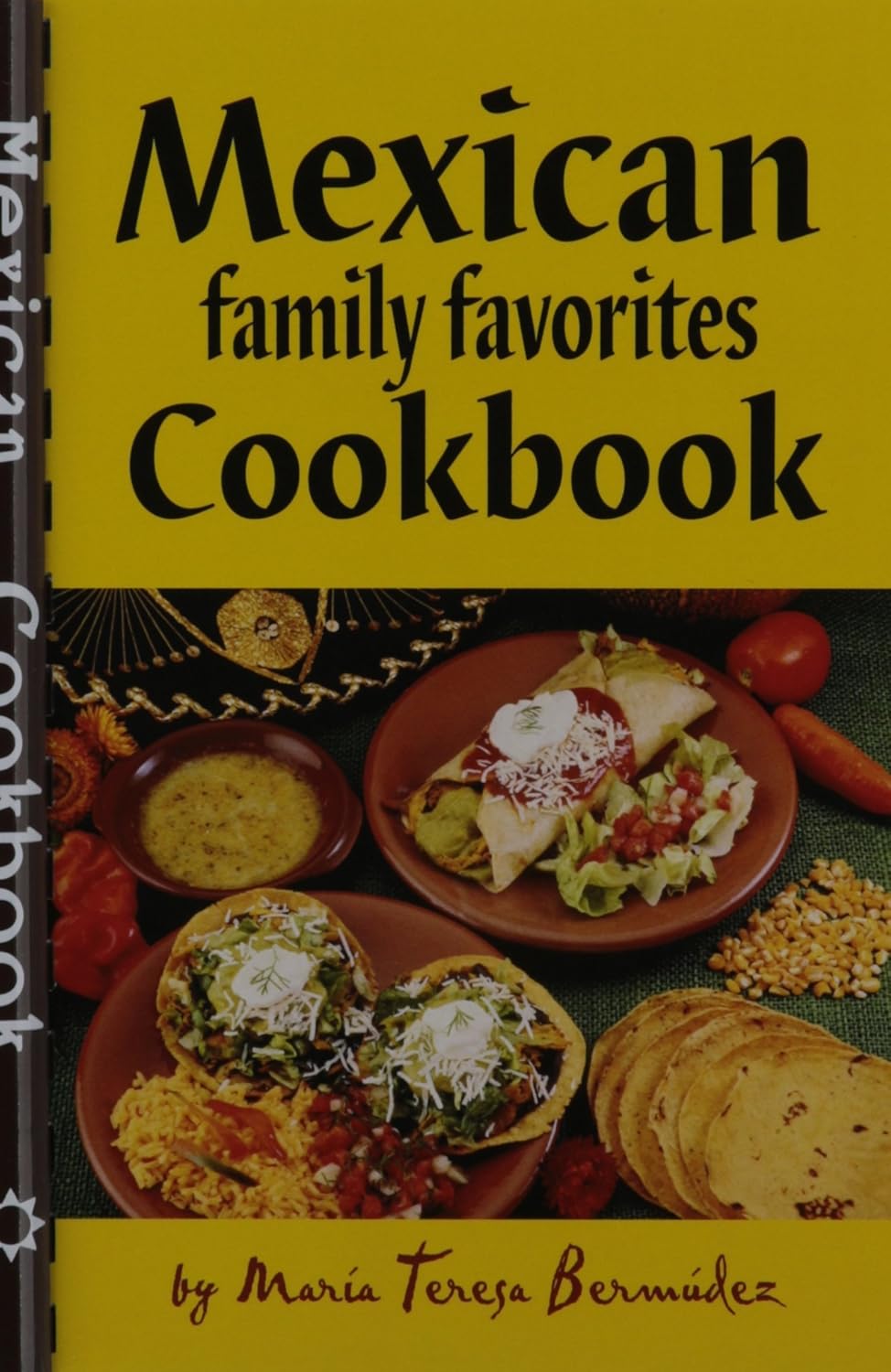 Mexican Family Favorites Cook Book by Maria Teresa Bermudez features a yellow cover with a table full of plates with tortillas, enchiladas, salsa, rice, and beans, open-faced tortillas with toppings, and a sombrero.