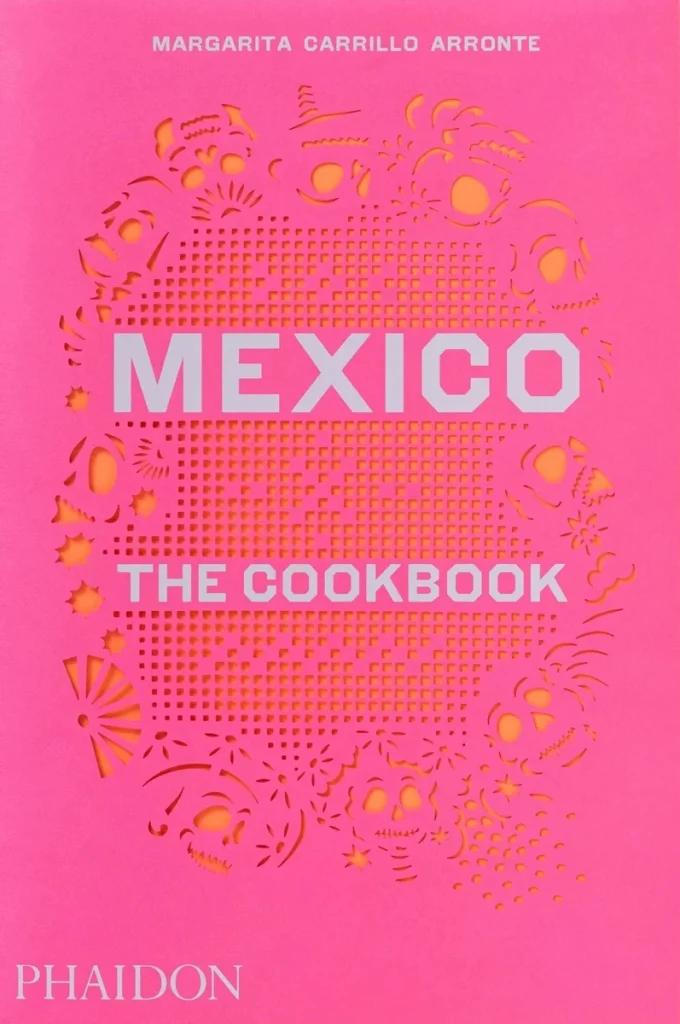 Mexico: The Cookbook by Margarita Carrillo Arronte depicts a pink cover with a traditional Mexican embroidered design behind the title.