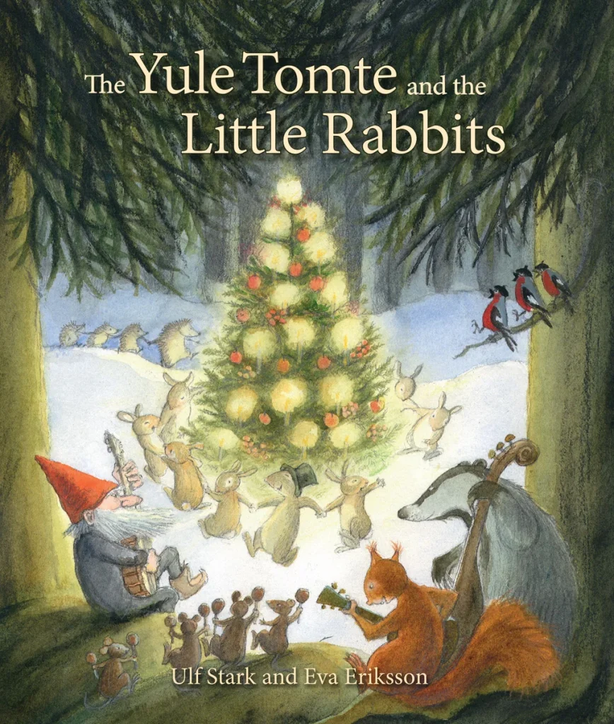 The Yule Tomte and the Little Rabbits: A Christmas Story for Advent by Ulf Stark, illustrated by Eva Eriksson, and translated by Susan Beard, features the woods with a lit and decorated Christmas tree with forest animals dancing around it. Towards the front of the cover, there is a gnome, birds, squirrels, chipmunks, and a badger placing instruments.
