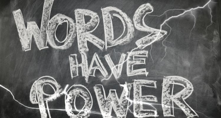 The phrase "WORDS HAVE POWER" displayed in large, weathered white letters against a dark, stormy background. Lightning bolts streak across the image, creating dramatic electrical effects that emphasize the powerful message about the impact and influence of language and communication.