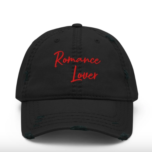 A black baseball cap with "Romance Lover" embroidered in red cursive on the front.