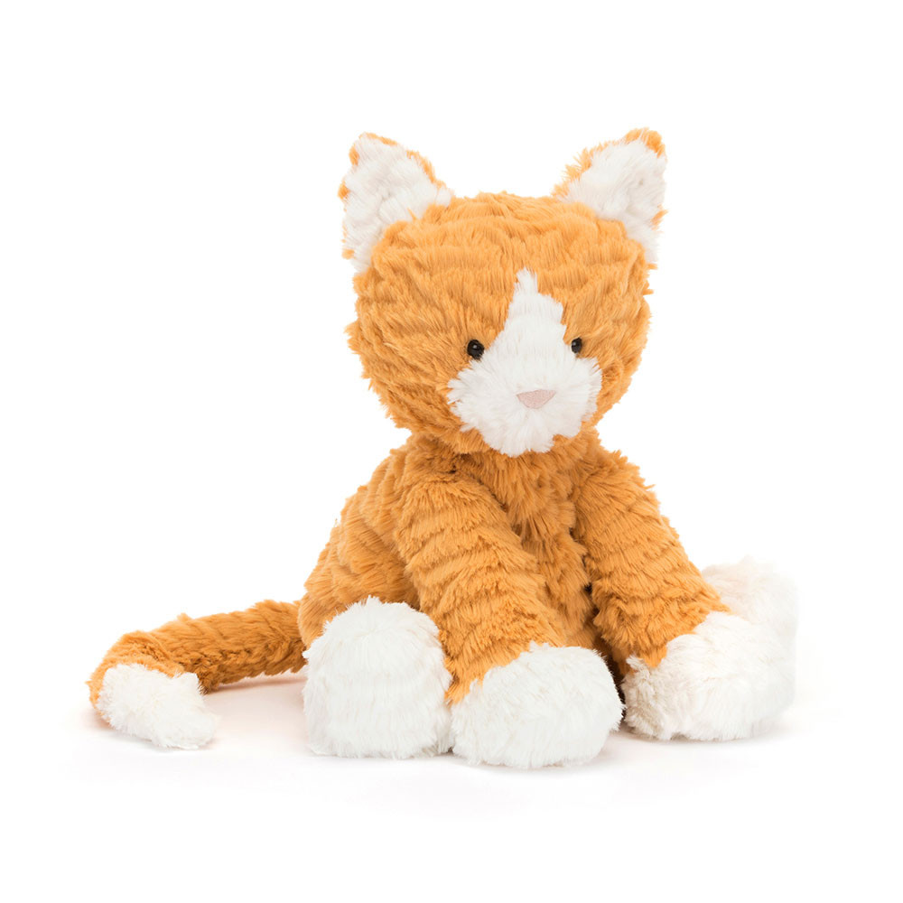 A plush orange and white kitten toy sits upright on a white background. Its soft, textured fur and gentle expression convey warmth and playfulness.