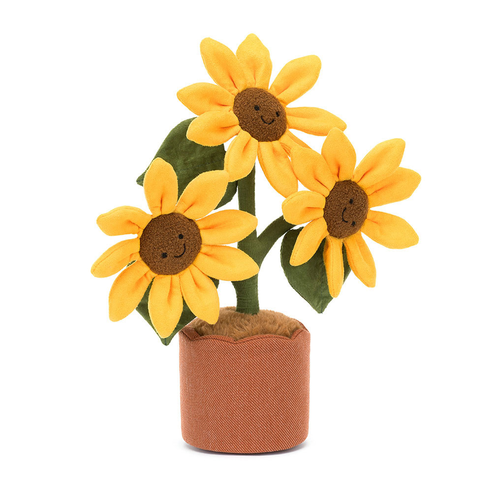 Three plush sunflowers with smiling faces in a brown pot. The sunflowers have yellow petals, brown centers, and green leaves, conveying a cheerful, whimsical tone.