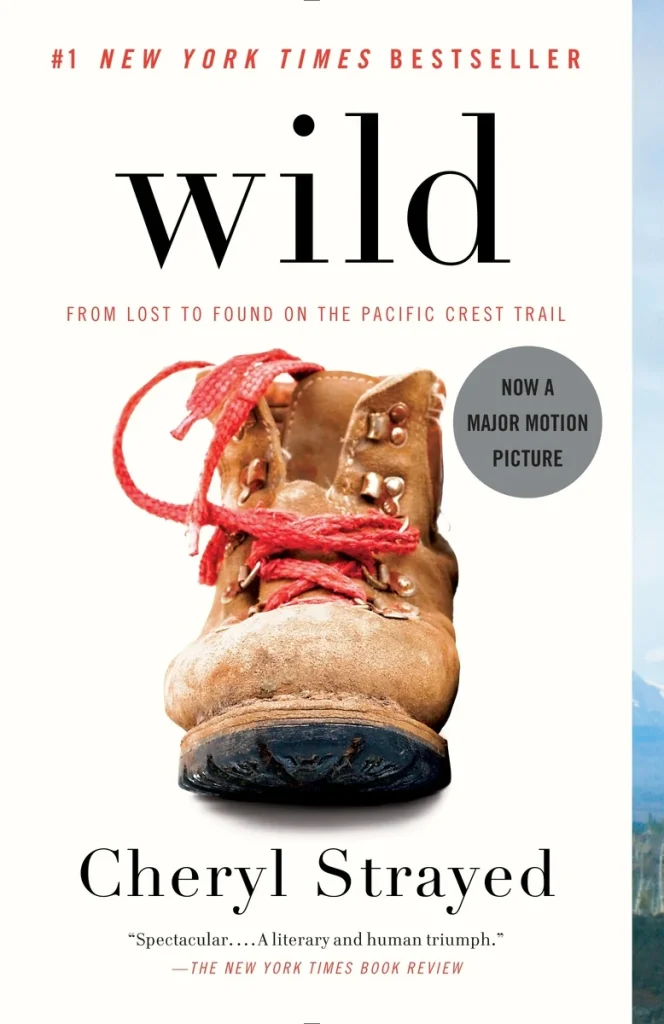 Wild by Cheryl Strayed book cover depicts a brown beat up hiking boot with red laces against a white background.