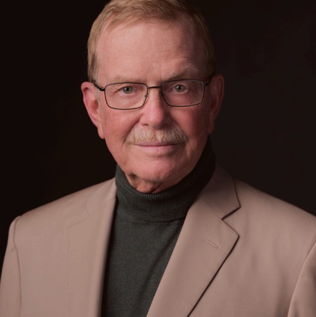 Headshot image of Randolph B Schiffer a light skinned older man with a mustache and glasses wearing a tan jacket and charcoal turtleneck.