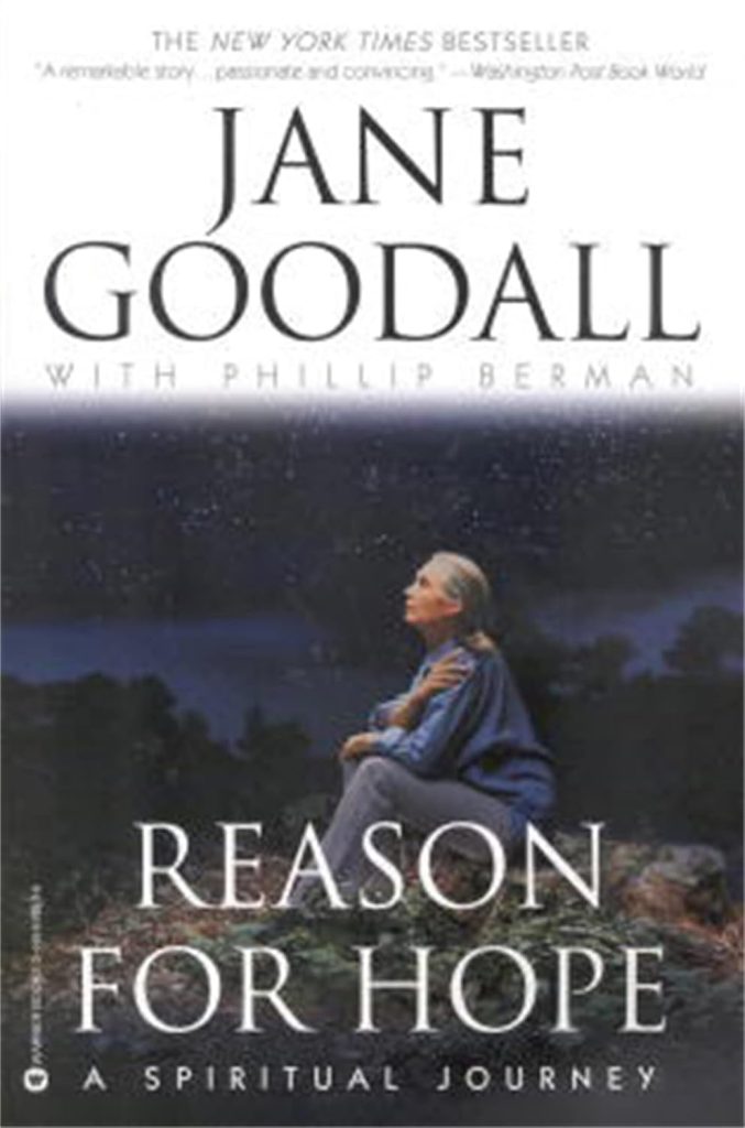 Reason for Hope by Jane Goodall with Phillip Berman book cover depicts Goodall sitting outside on the ground looking up at the sky against a dark background.