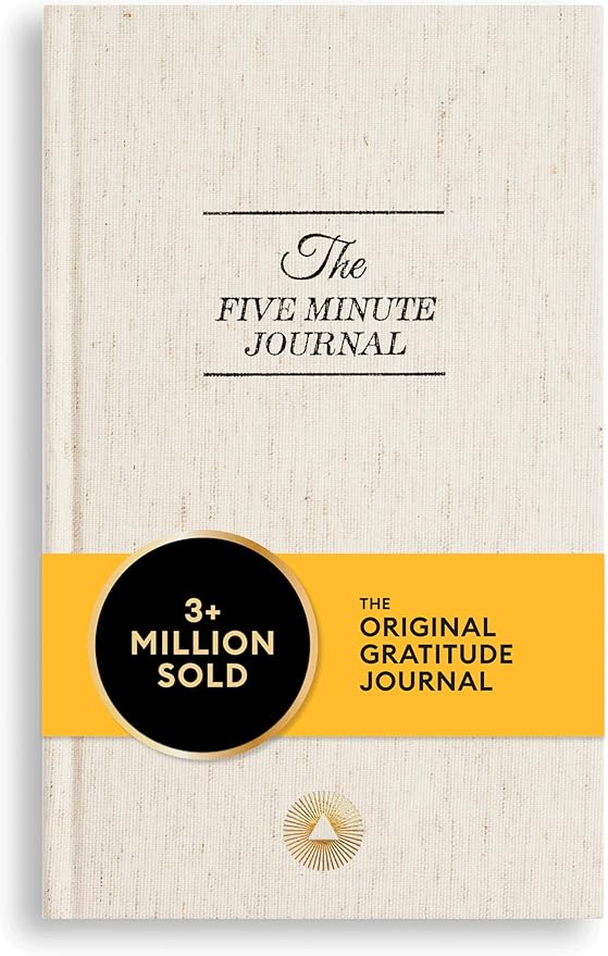 The Five Minute Journal cover in a hard copy format with the title in elegant, dark font against a beige background.