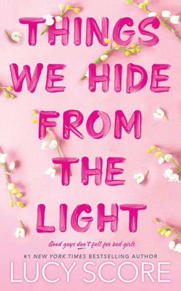 Book cover of "Things We Hide From the Light" by Lucy Score. White flowers border the edges. At the bottom, it reads, “Good guys don't fall for bad girls."