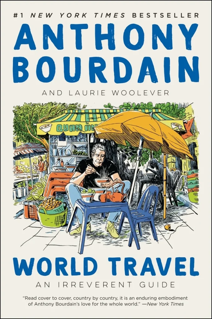 World Travel: An Irreverent Guide by Anthony Bourdain and Laurie Woolever features Anthony Bourdain sitting at a table with food in his hands, sitting in front of a little marketplace with other people and trees surrounding him.