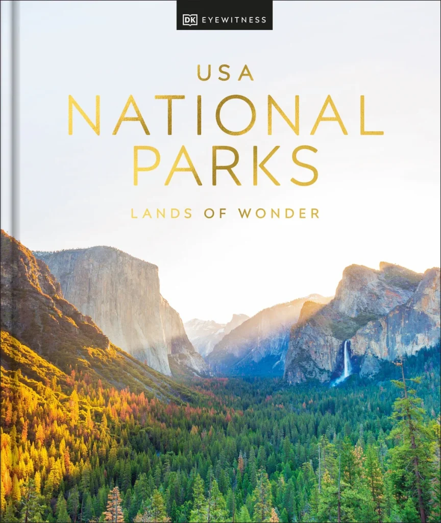 USA National Parks: Lands of Wonder by DK Travel features a bunch of rolling mountains with a forest in front. Over the title and the mountains is a ray of sunshine.
