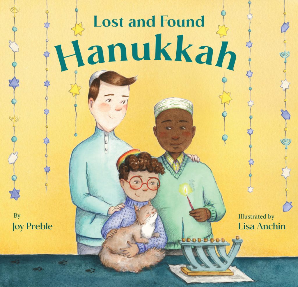 Lost and Found Hanukkah by Esther Brenner, illustrated by Andrea Stegmaier, a cheerful holiday picture book cover depicting a young boy holding a cat beside his two dads, one of whom is lighting a menorah. The background is bright yellow with star garlands, and the title appears at the top.