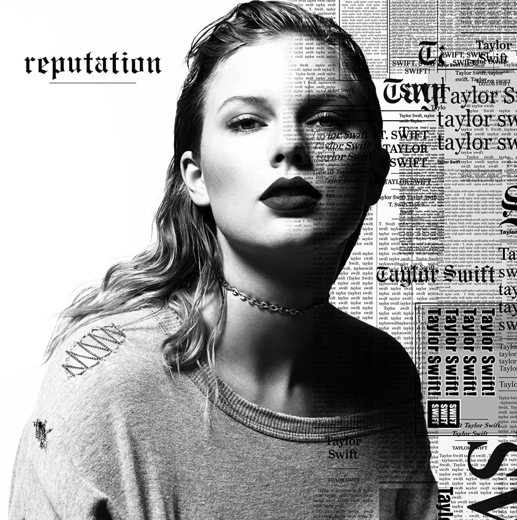 The album cover for reputation by Taylor Swift. Taylor Swift is featured in black and white, wearing a chain choker necklace and a distressed sweatshirt. Over half of her face is newspaper headings featuring her name listed over and over.