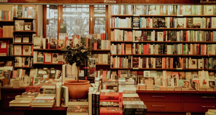 Library shelves and tables covered in books