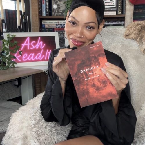 BookstagrammerAshley holding the classic book Dracula by Bram Stoker.